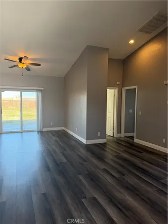 an empty room with wooden floor and a window