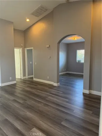 a view of a room with wooden floor