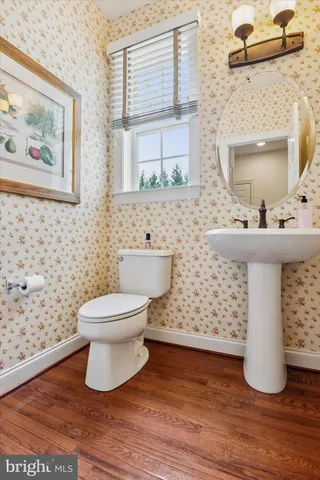 a bedroom with a bed and large windows