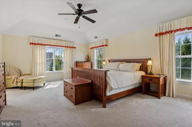 a bedroom with furniture and a flat screen tv
