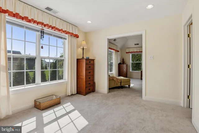 a living room with furniture a table and large window