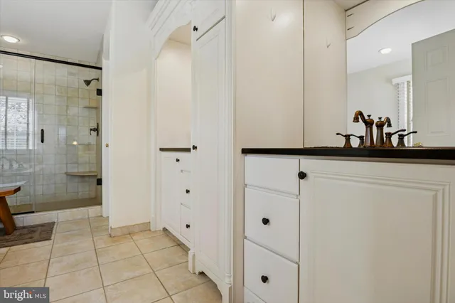 a living room with furniture a flat screen tv and a large window