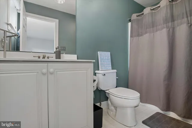 a kitchen with granite countertop a refrigerator a stove a sink and a cabinets