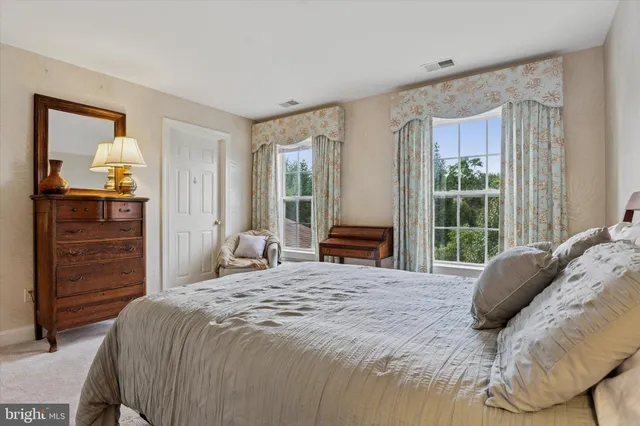 a view of a patio with a dining table and chairs with wooden fence