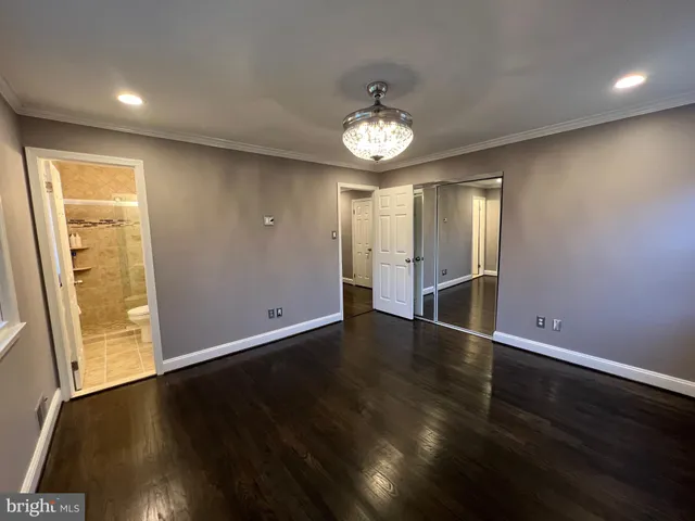 an empty room with wooden floor and door