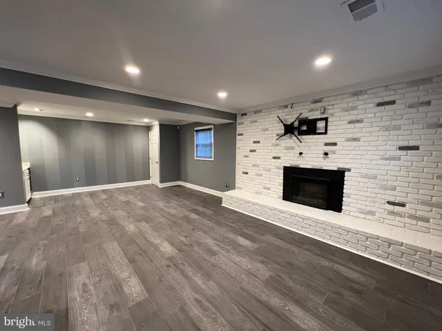 a view of a livingroom with an empty space and a fireplace