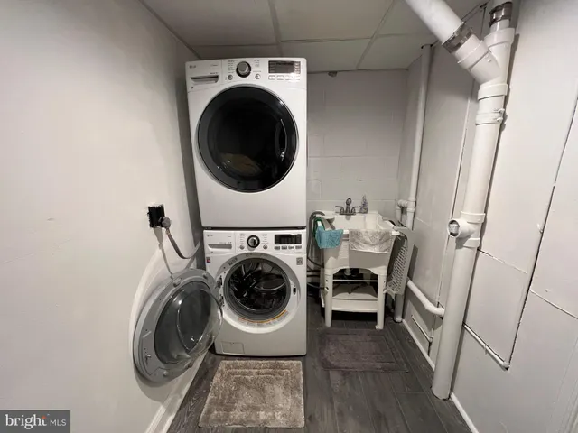 a view of a deck with a table and chairs a barbeque with wooden fence and trees
