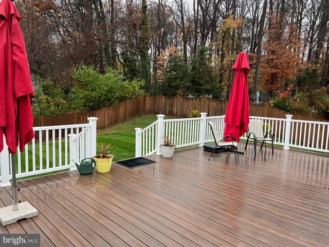 a view of a backyard with a small cabin and wooden fence