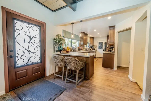 a dining room with stainless steel appliances kitchen island granite countertop a refrigerator and a stove top oven