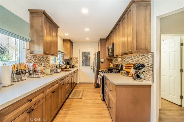 a kitchen with stainless steel appliances a sink stove and cabinets