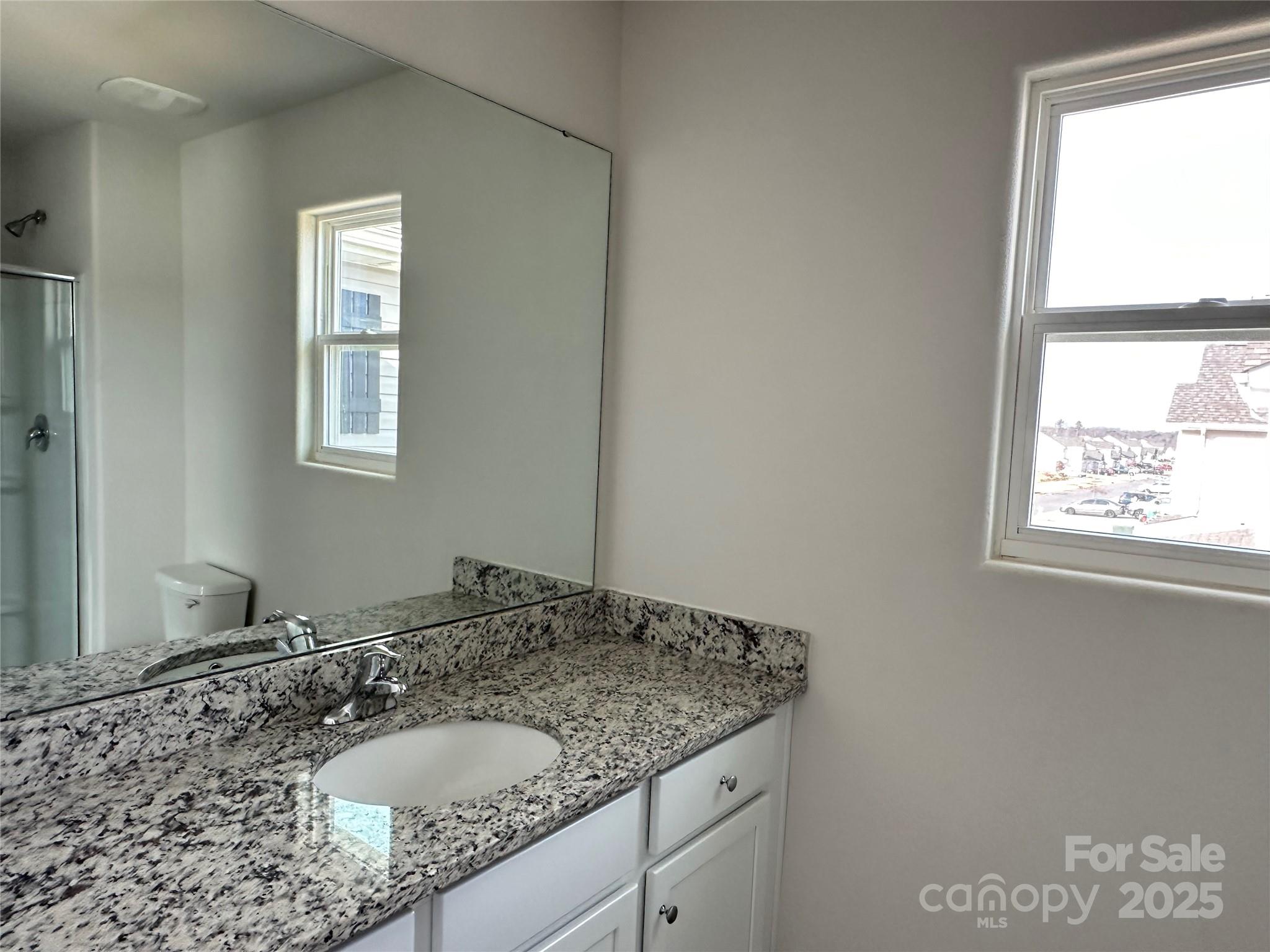 1345 Nia Road Charlotte, NC 28215 - Photo 11 of 19 a bathroom with a granite countertop sink and a window