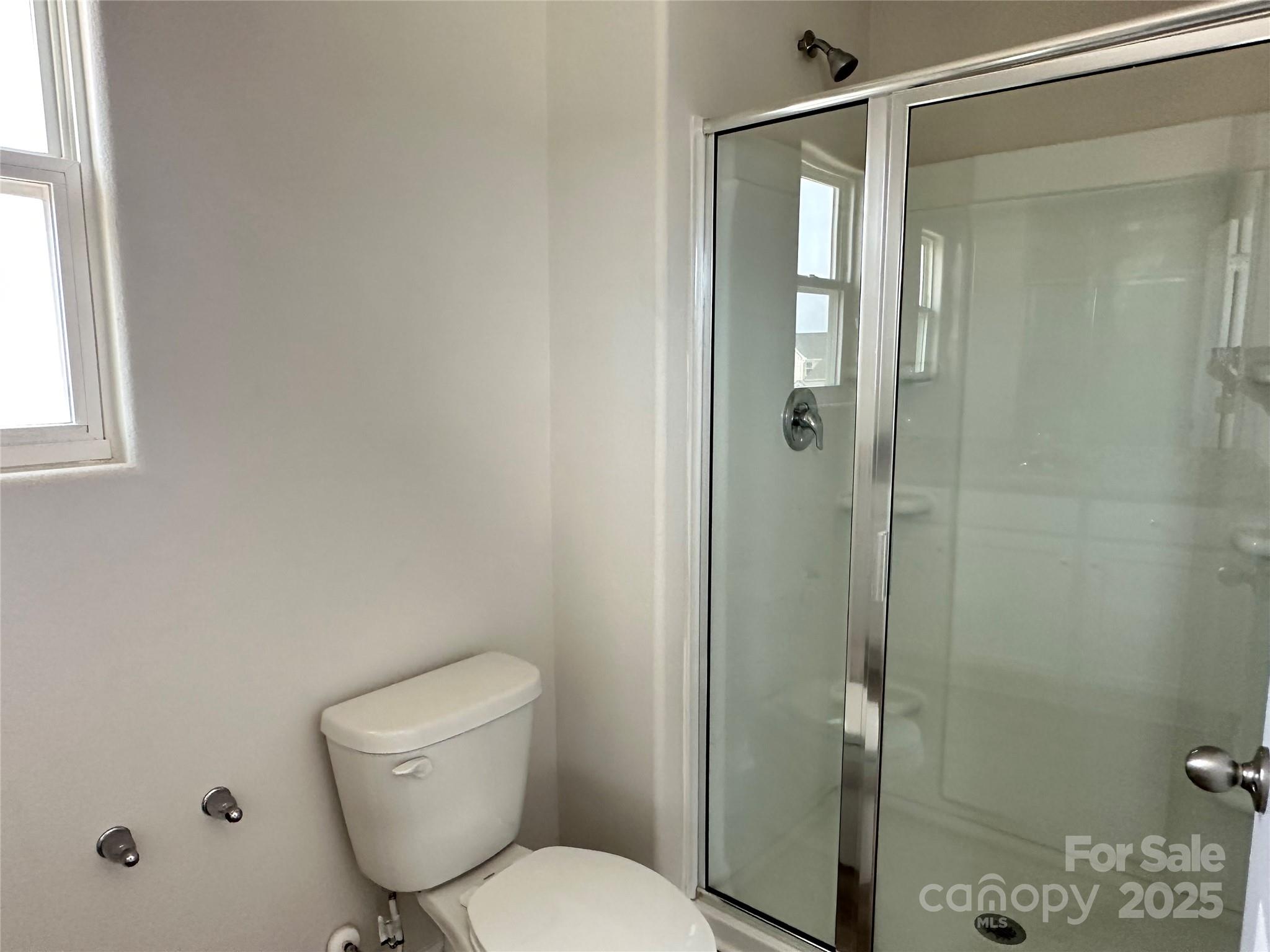 1345 Nia Road Charlotte, NC 28215 - Photo 12 of 19 a white toilet sitting next to a bathroom sink