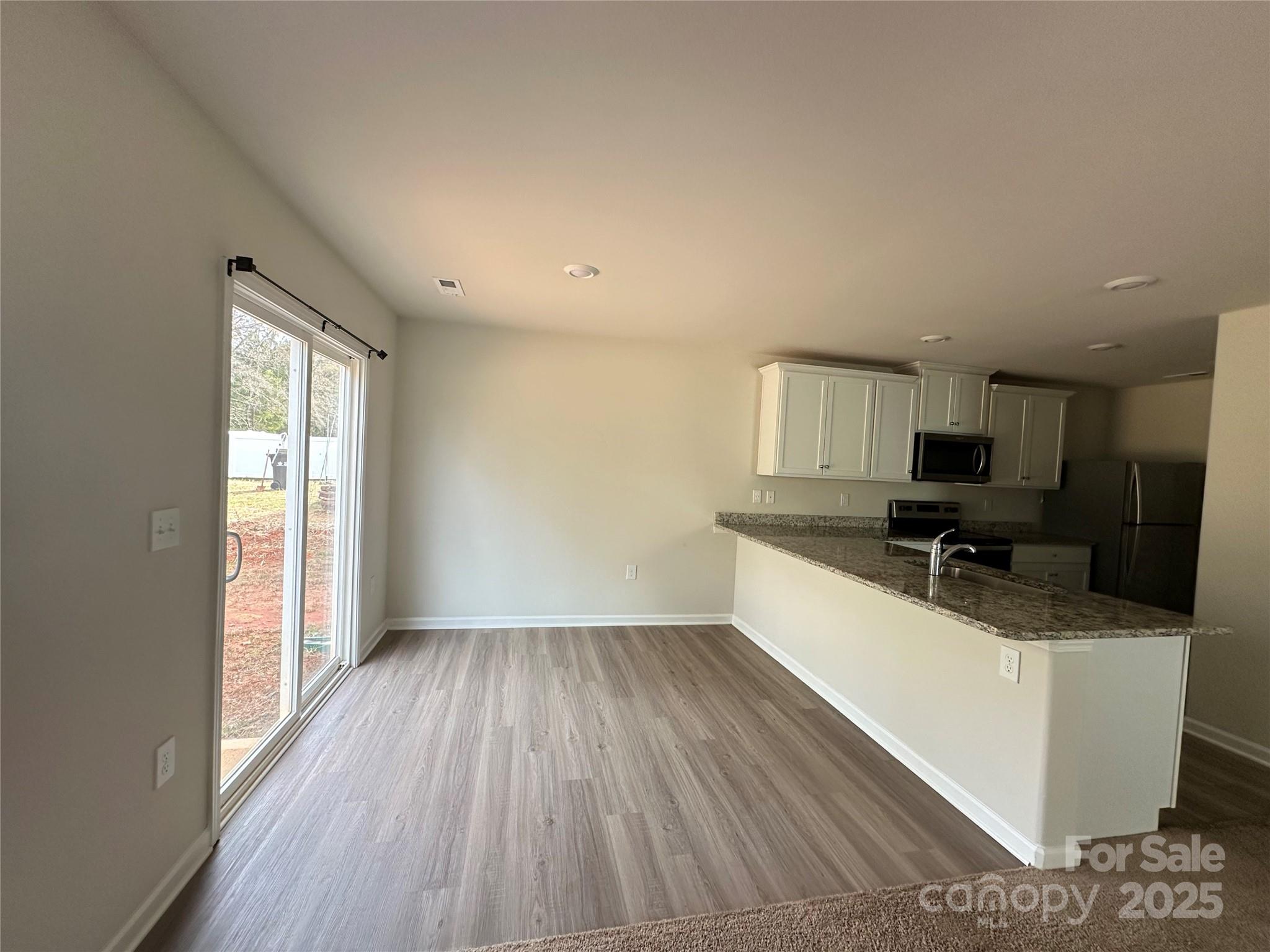 1345 Nia Road Charlotte, NC 28215 - Photo 5 of 19 a view of a kitchen with a sink and a large window