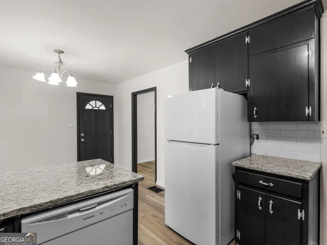 a kitchen with a refrigerator and a sink