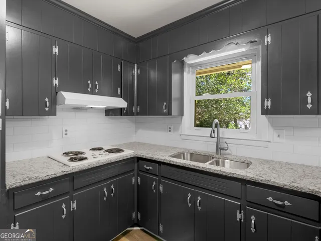 a kitchen with a sink cabinets and window