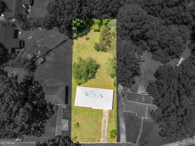 a aerial view of a residential houses with yard
