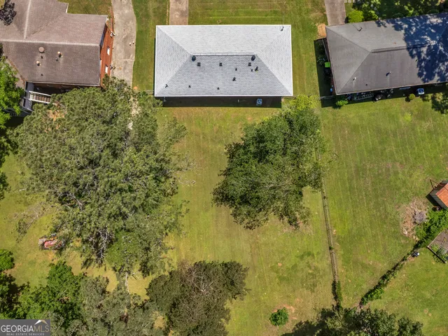 an aerial view of residential house with pool and yard