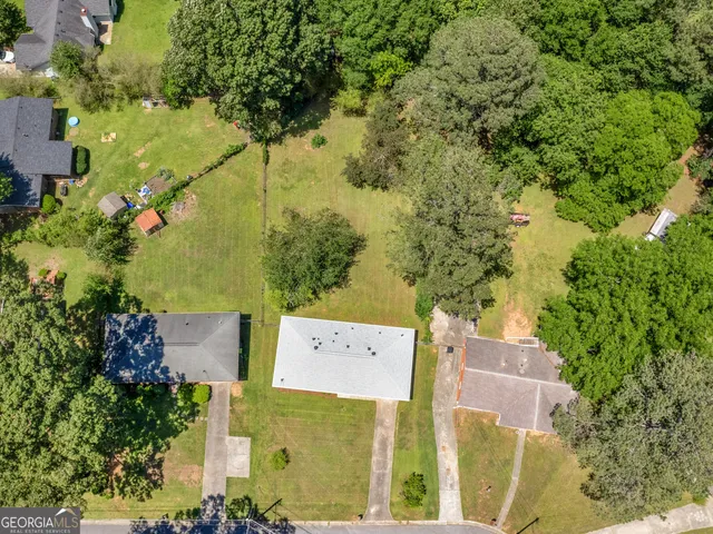 an aerial view of a house with a yard