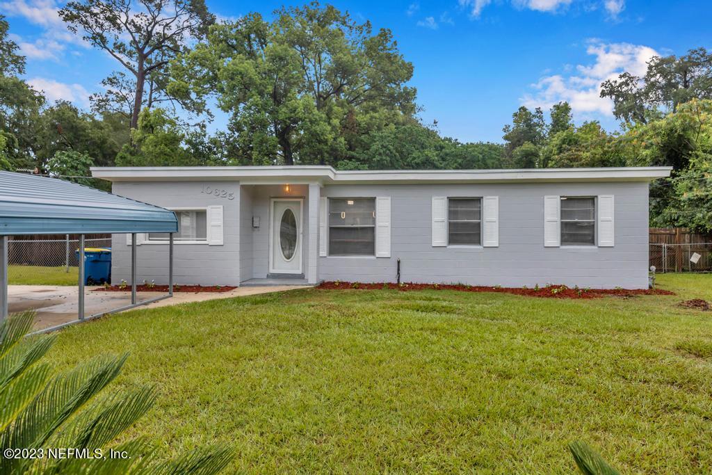 10625 Rutgers Road Jacksonville, FL 32218 - Photo 1 of 37 a backyard of a house with yard and outdoor seating