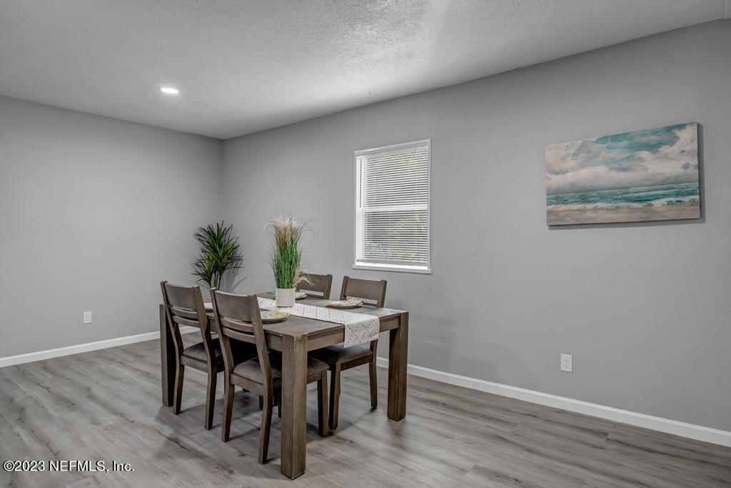 10625 Rutgers Road Jacksonville, FL 32218 - Photo 13 of 37 a view of a dining room with furniture and wooden floor
