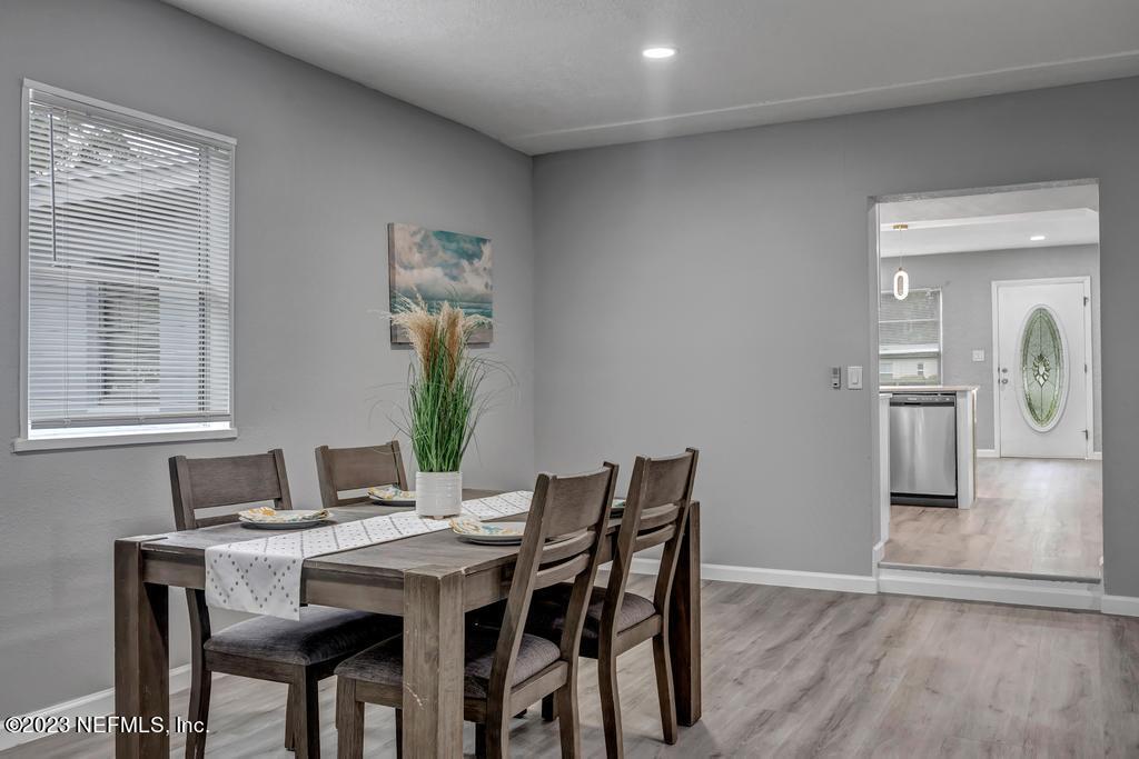 10625 Rutgers Road Jacksonville, FL 32218 - Photo 15 of 37 a view of a dining room with furniture and wooden floor