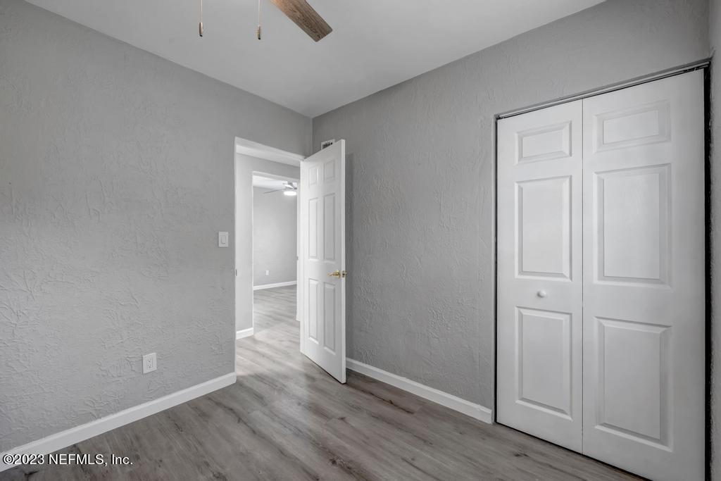 10625 Rutgers Road Jacksonville, FL 32218 - Photo 25 of 37 an empty room with wooden floor and closet