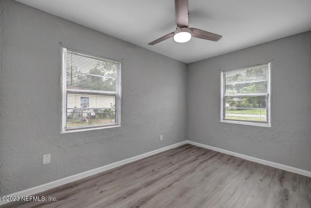 10625 Rutgers Road Jacksonville, FL 32218 - Photo 26 of 37 a view of an empty room with wooden floor and a window