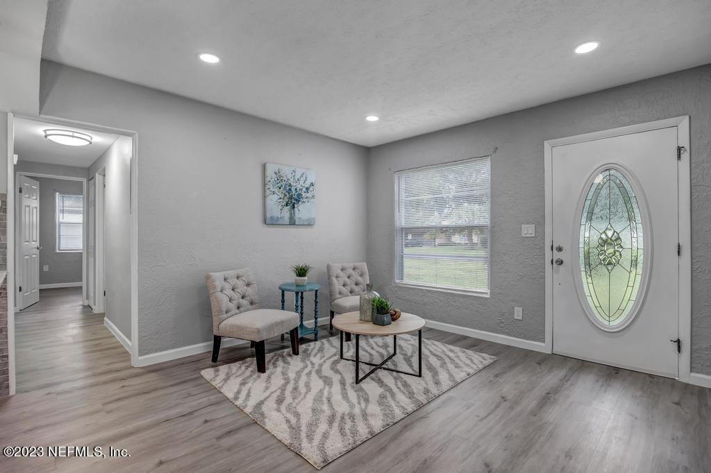 10625 Rutgers Road Jacksonville, FL 32218 - Photo 6 of 37 a living room with furniture a window and wooden floor