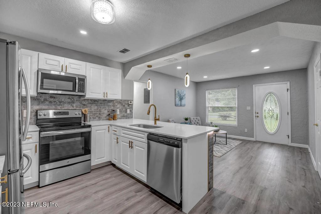10625 Rutgers Road Jacksonville, FL 32218 - Photo 10 of 37 a kitchen with a sink appliances and cabinets