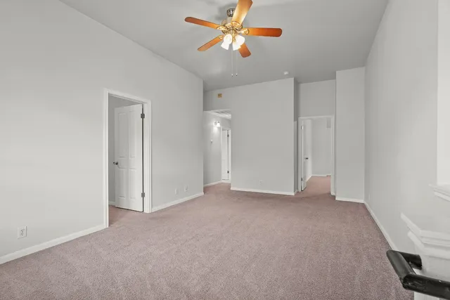a view of a big room with chandelier fan and closet