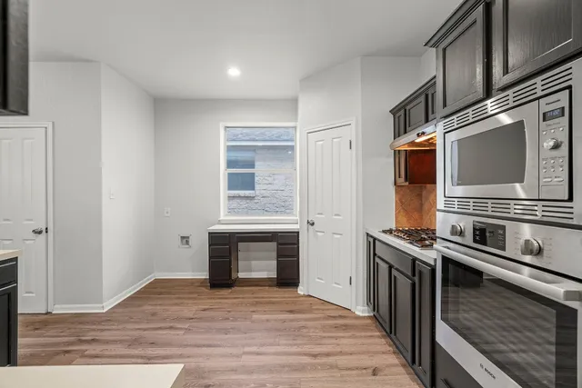 a kitchen with stainless steel appliances granite countertop a stove and a microwave