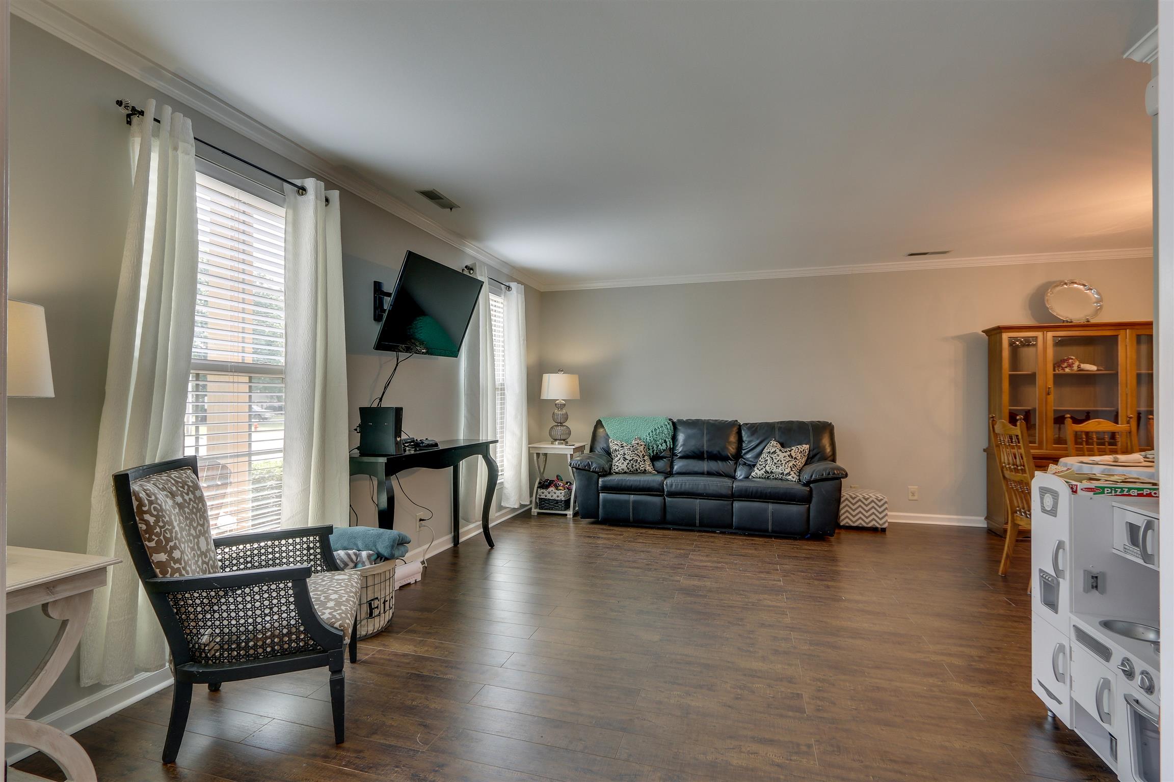812 General George Patton Road, Unit 812 Nashville, TN 37221 - Photo 5 of 28 a living room with furniture and a flat screen tv