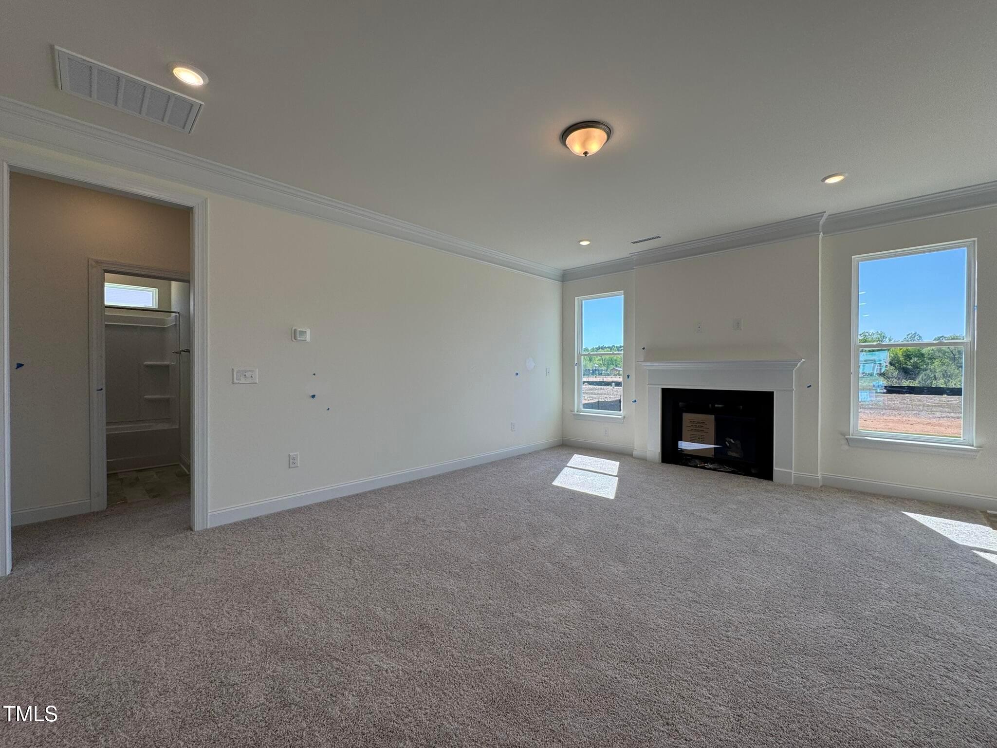 75 Steppe Way Garner, NC 27529 - Photo 11 of 39 an empty room with windows and fireplace
