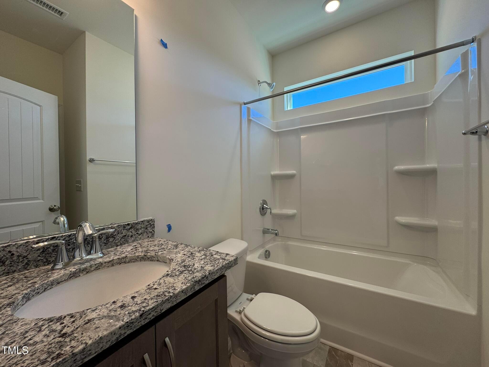 75 Steppe Way Garner, NC 27529 - Photo 12 of 39 a bathroom with a granite countertop sink a toilet and shower