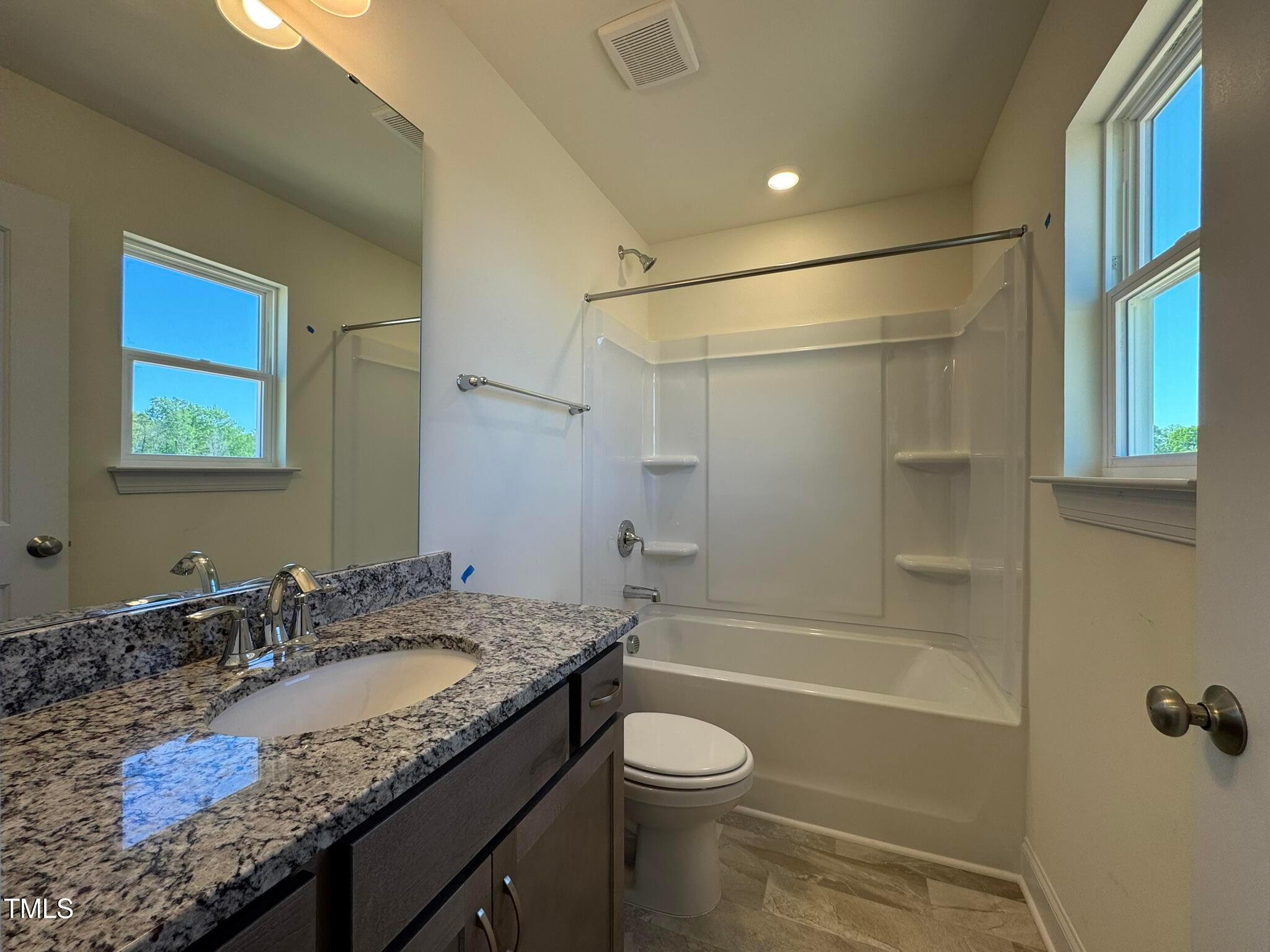 75 Steppe Way Garner, NC 27529 - Photo 22 of 39 a bathroom with a granite countertop sink toilet and shower