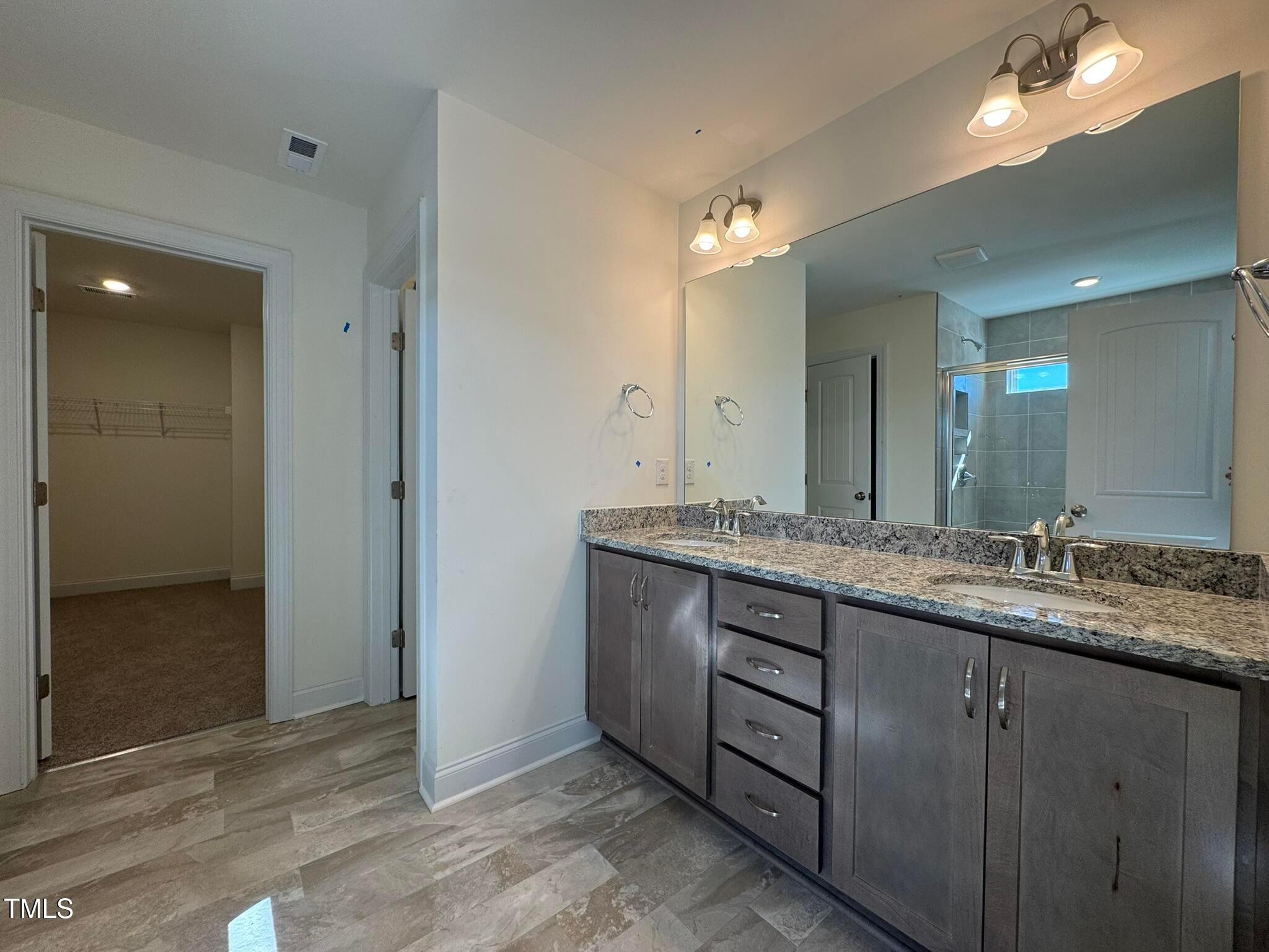 75 Steppe Way Garner, NC 27529 - Photo 27 of 39 a bathroom with a granite countertop sink and a mirror