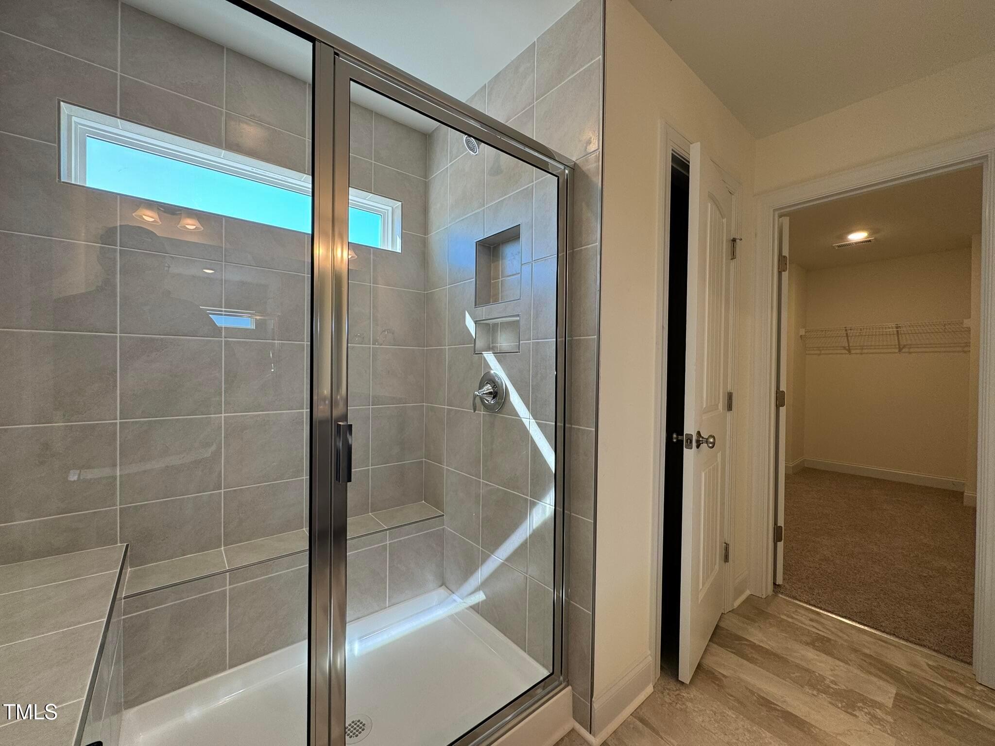 75 Steppe Way Garner, NC 27529 - Photo 28 of 39 a bathroom with a glass shower door