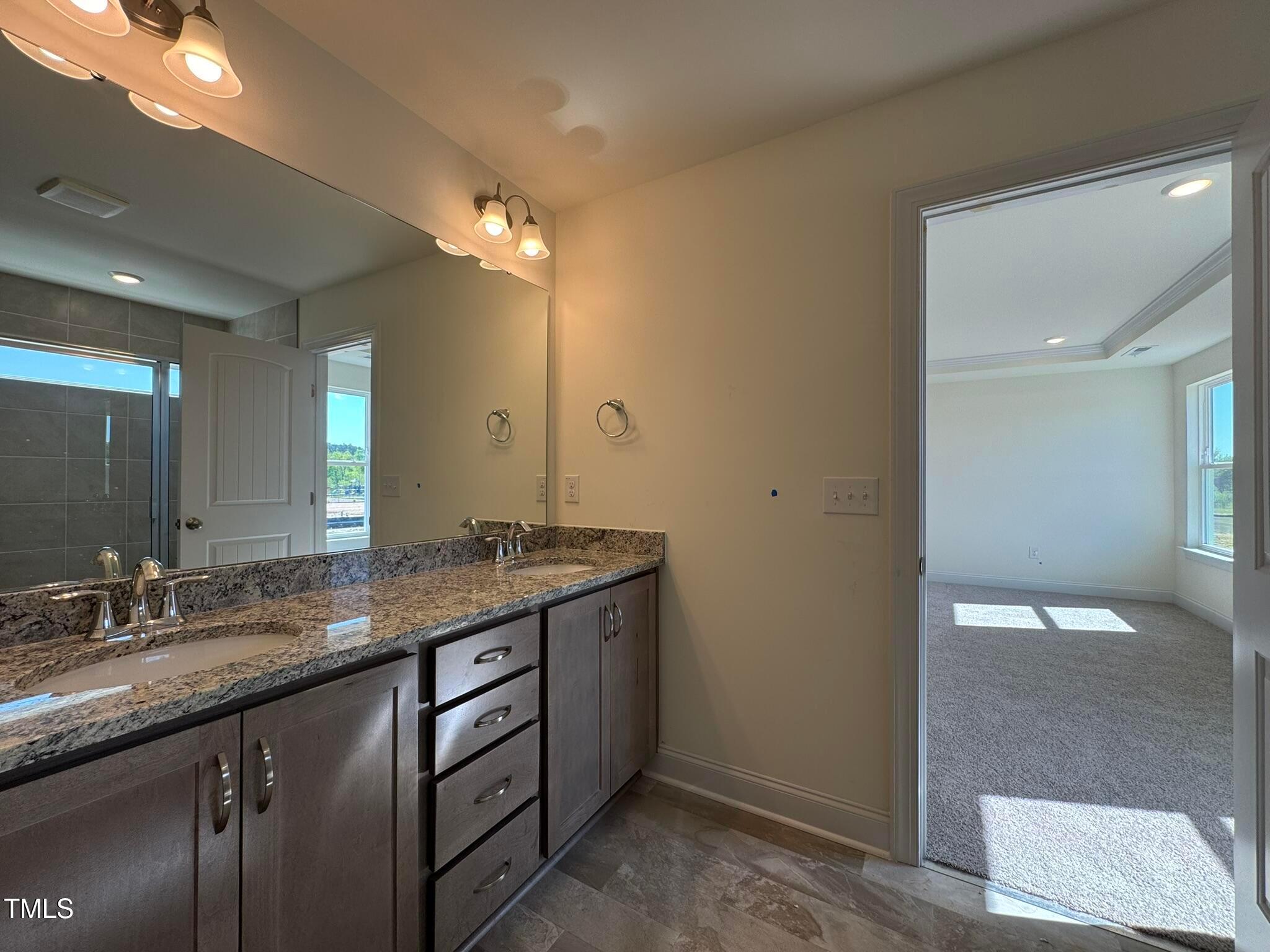 75 Steppe Way Garner, NC 27529 - Photo 30 of 39 a bathroom with a granite countertop sink a toilet and a large mirror