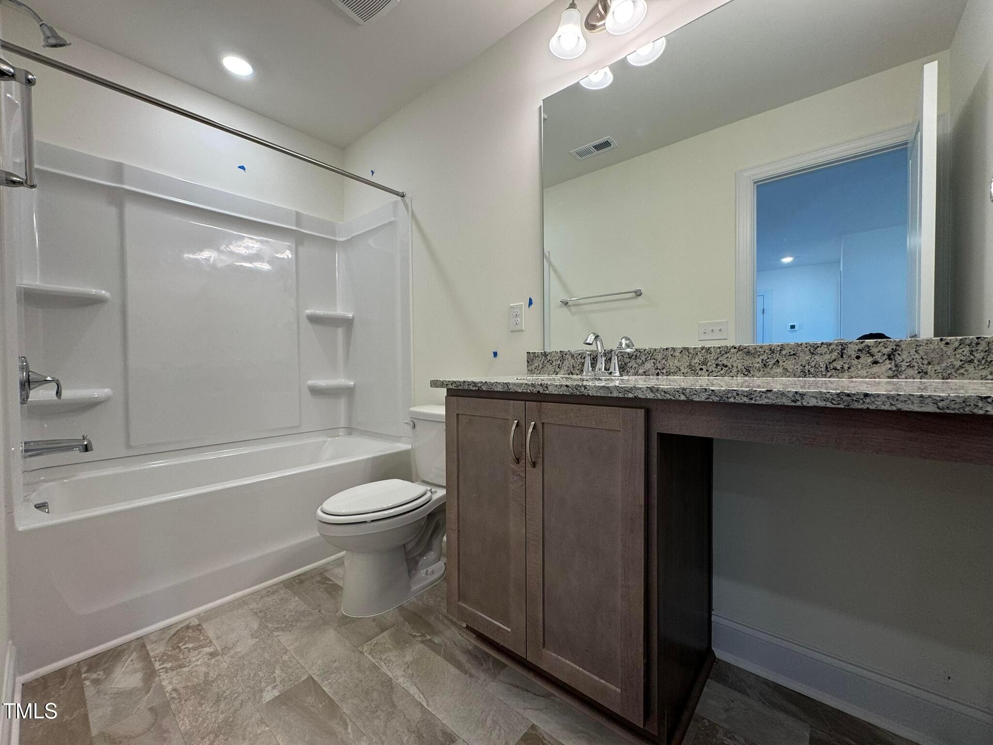 75 Steppe Way Garner, NC 27529 - Photo 34 of 39 a bathroom with a granite countertop toilet sink and mirror