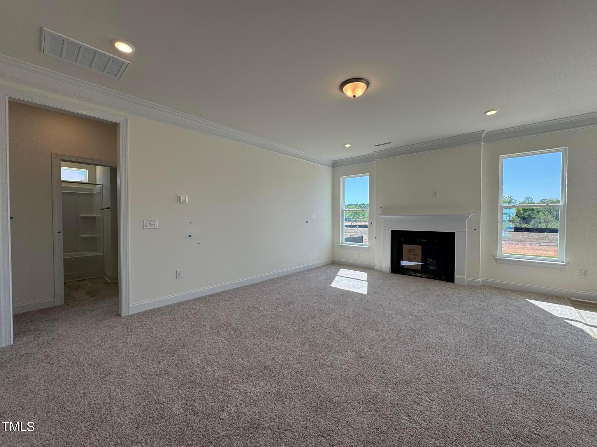 75 Steppe Way Garner, NC 27529 - Photo 6 of 39 an empty room with windows and fireplace