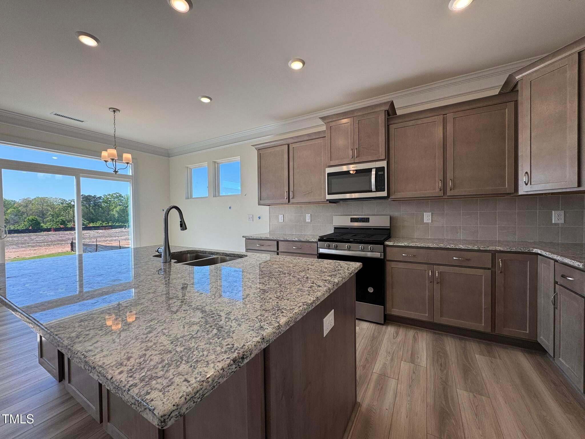 75 Steppe Way Garner, NC 27529 - Photo 7 of 39 a kitchen with a stove sink and microwave