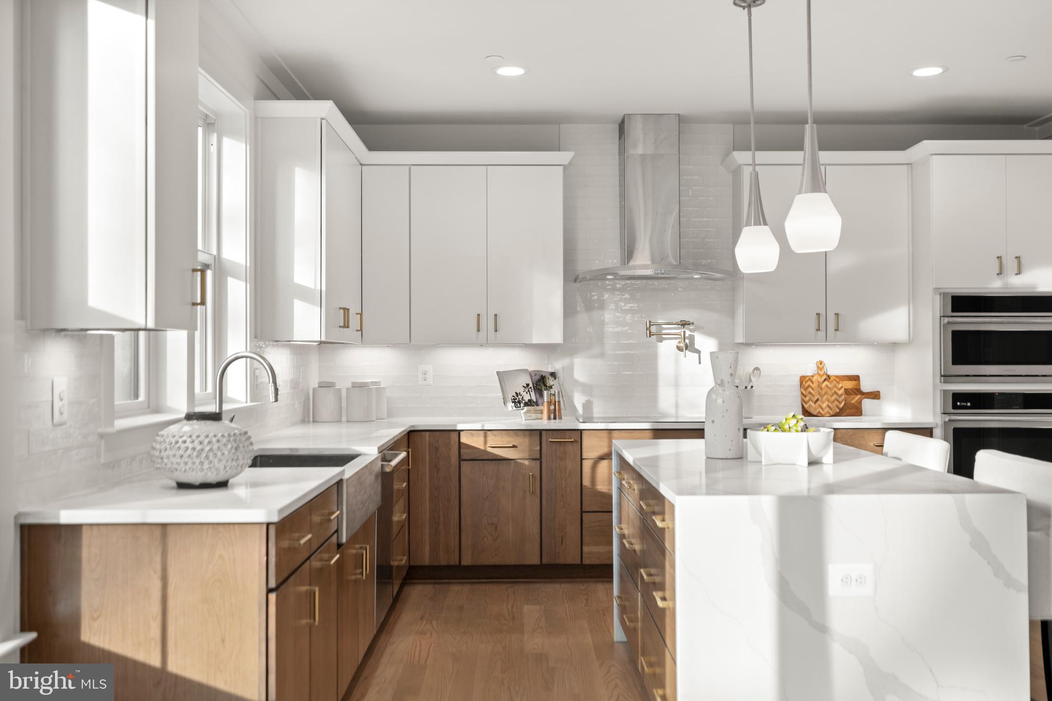 8506 Hempstead Avenue Bethesda, MD 20817 - Photo 16 of 57 a kitchen with a sink a counter space appliances and cabinets