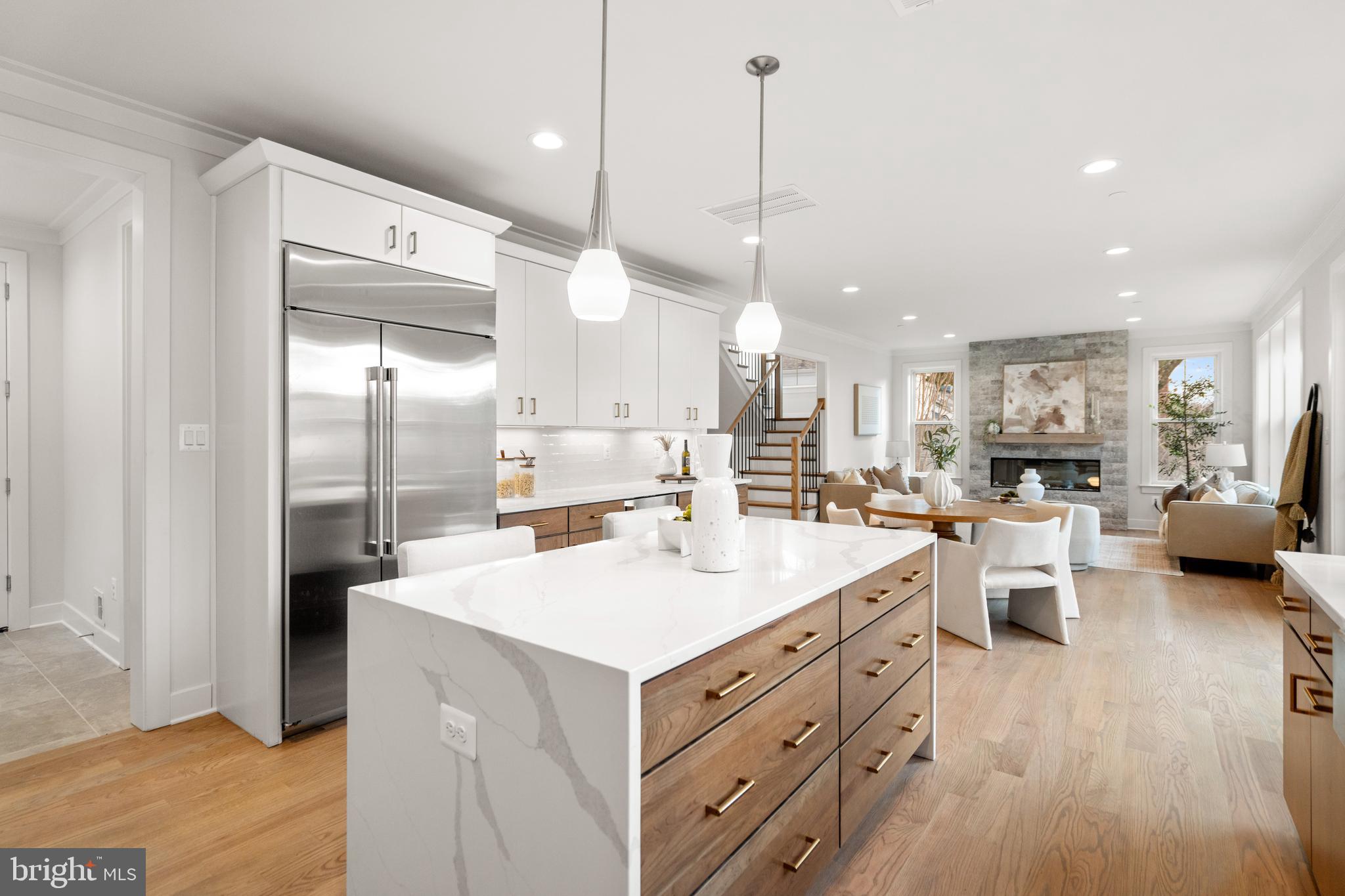 8506 Hempstead Avenue Bethesda, MD 20817 - Photo 20 of 57 a large kitchen with kitchen island a large counter space a sink appliances and a floor