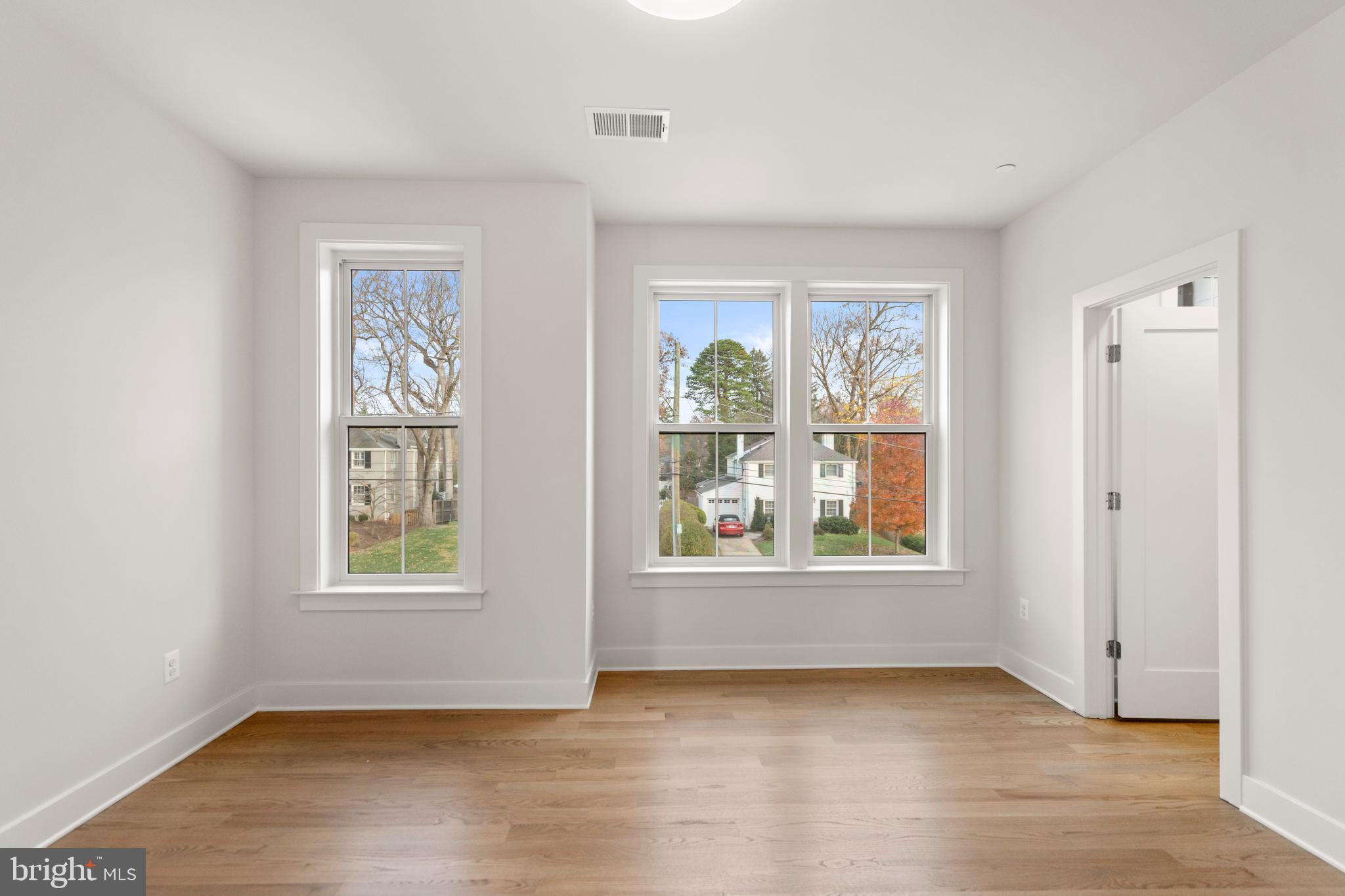 8506 Hempstead Avenue Bethesda, MD 20817 - Photo 35 of 57 an empty room with wooden floor and windows