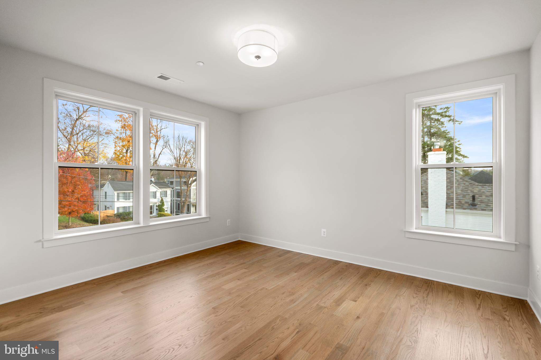 8506 Hempstead Avenue Bethesda, MD 20817 - Photo 38 of 57 an empty room with wooden floor and windows
