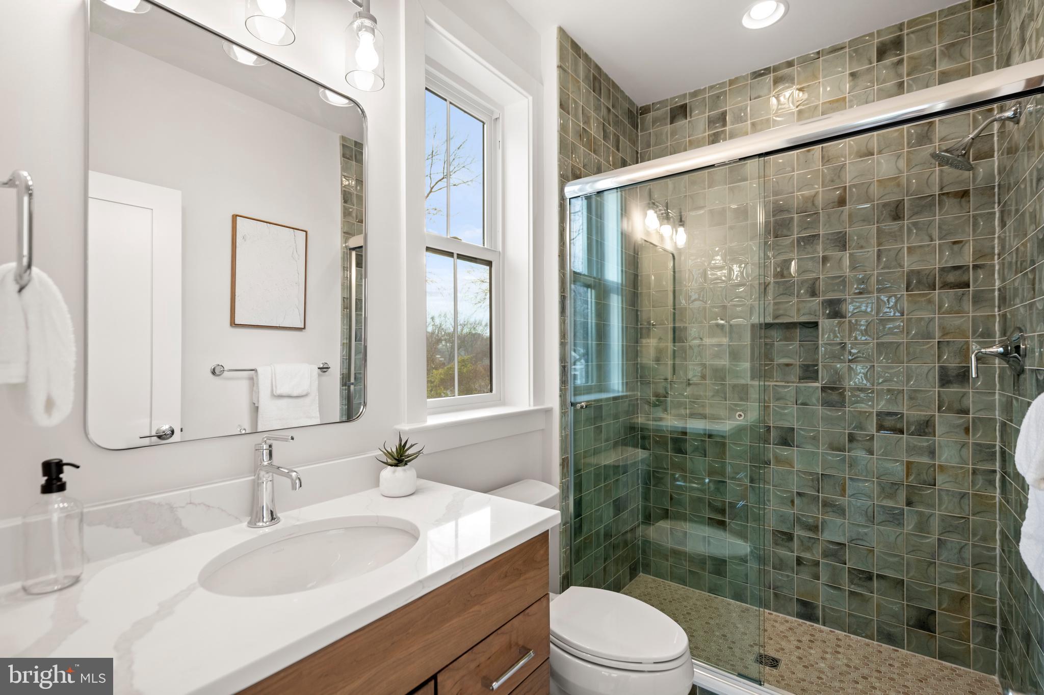8506 Hempstead Avenue Bethesda, MD 20817 - Photo 40 of 57 a bathroom with a sink shower and a mirror