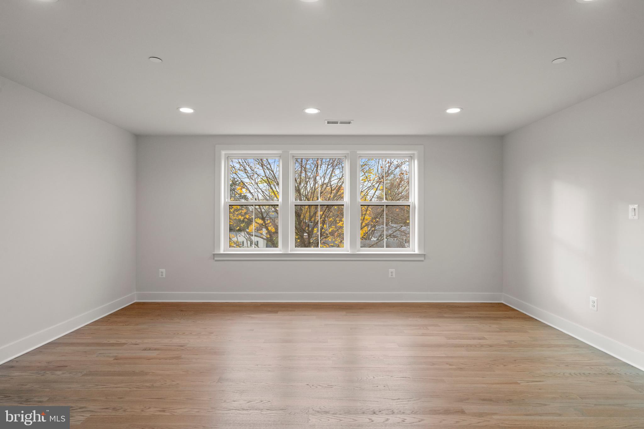 8506 Hempstead Avenue Bethesda, MD 20817 - Photo 42 of 57 an empty room with wooden floor and window