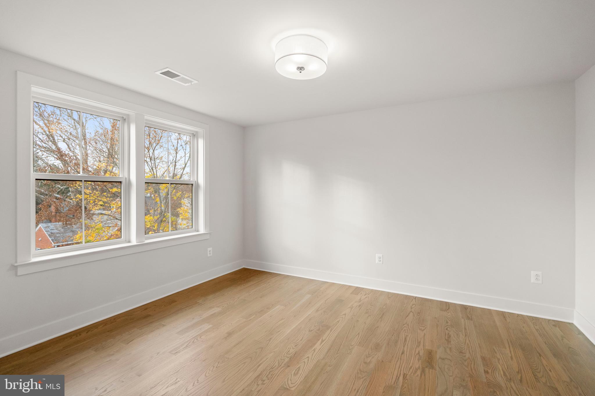 8506 Hempstead Avenue Bethesda, MD 20817 - Photo 44 of 57 an empty room with wooden floor and windows