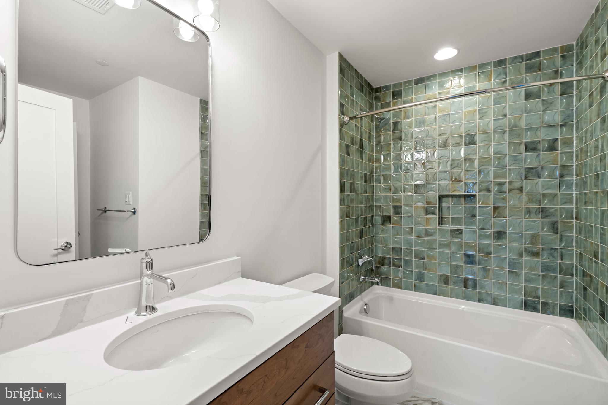 8506 Hempstead Avenue Bethesda, MD 20817 - Photo 46 of 57 a bathroom with a bathtub shower sink mirror vanity and toilet