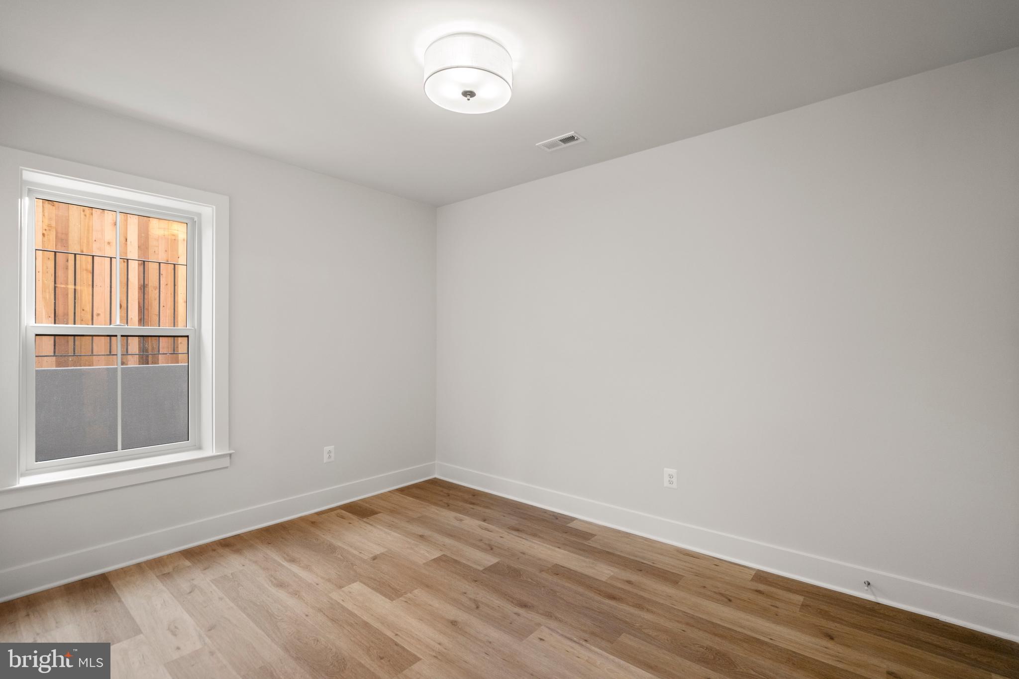 8506 Hempstead Avenue Bethesda, MD 20817 - Photo 51 of 57 wooden floor in an empty room with a window